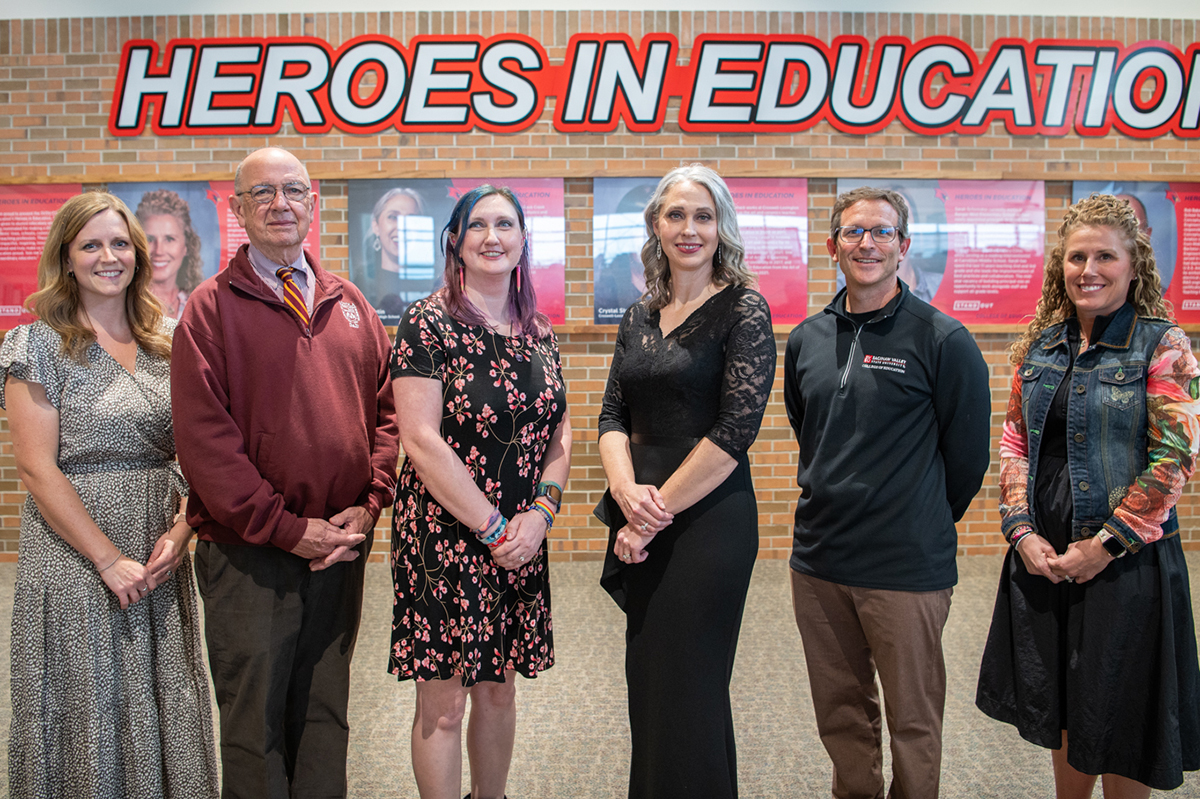 Group of men and women standing shoulder to shoulder